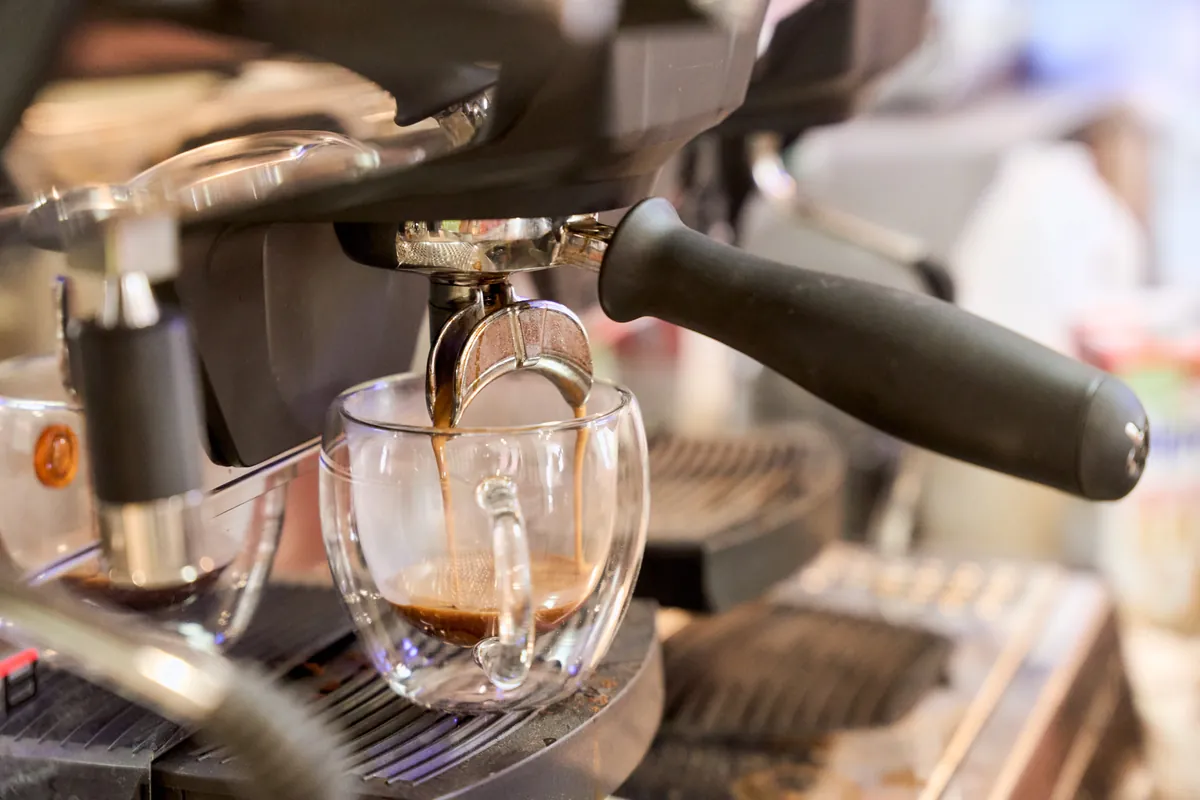 Barista-quality espresso pouring into a glass cup at The Willow Bean's coffee machine