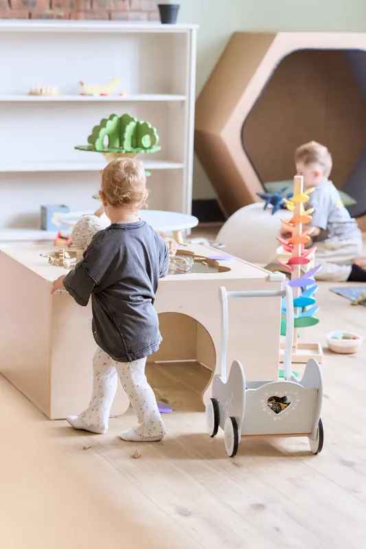 Toddlers exploring the sensory table and toddler play space at The Willow Bean Play Cafe